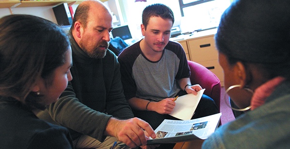 students sitting in a group discussing item in an article