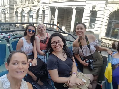Students on an open-top city tour bus in Liverpool