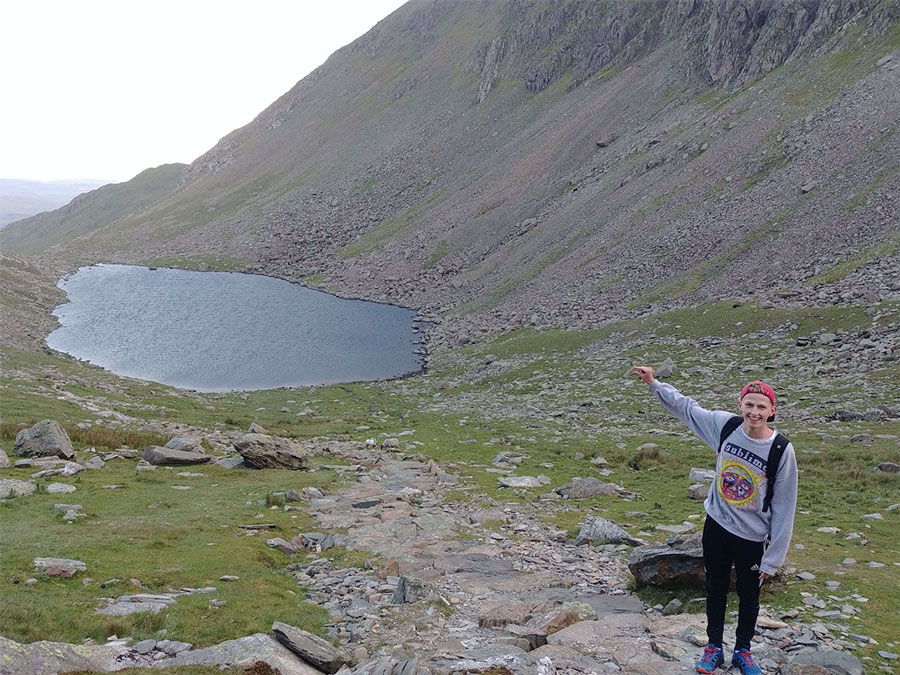 Student enjoying the view over a lake within the mountain