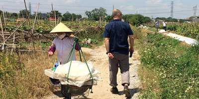 Men walk through an irrigated field
