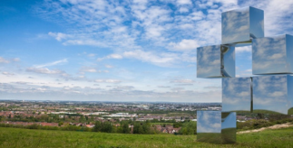 A green meadow on a sunny day with transparent square blocks on the right hand side.