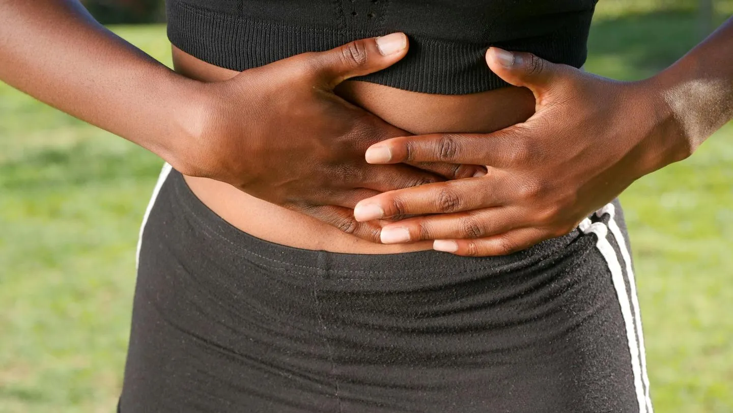 Woman holds her abdomen