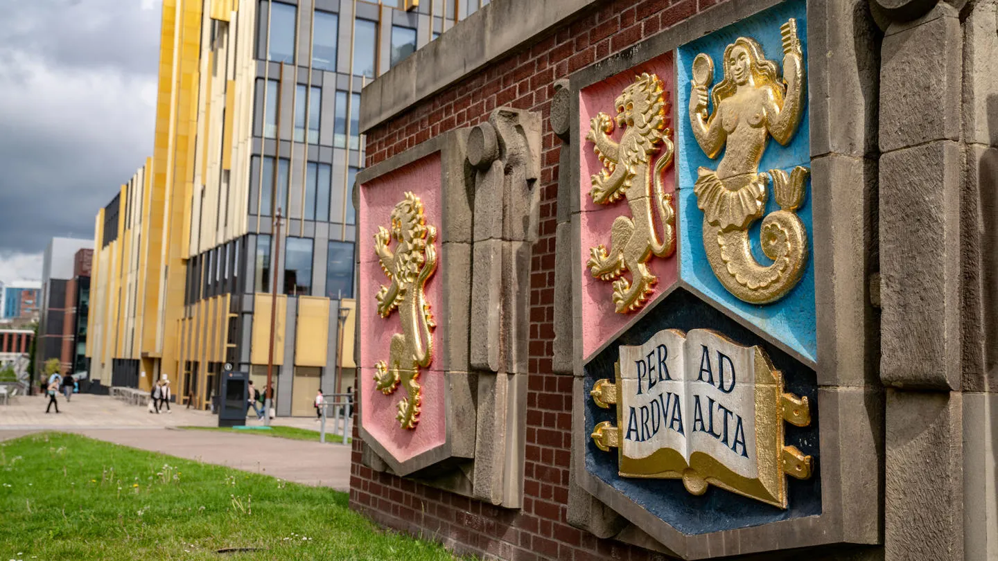 University of Birmingham crest on a wall on campus.