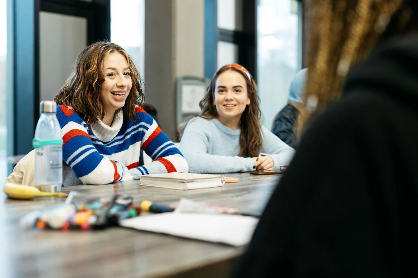 Two people sitting at a table laughing